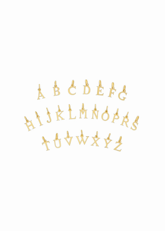 Gold metal alphabet letter charms arranged in three rows on a plain white background.
